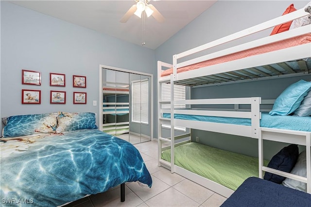 bedroom featuring ceiling fan, vaulted ceiling, a closet, and tile patterned flooring