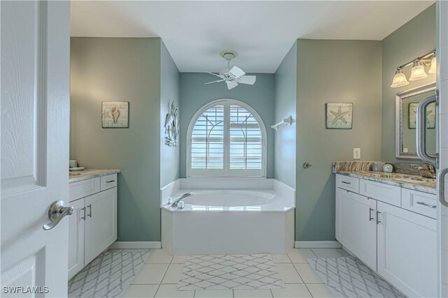 bathroom featuring a bathing tub, tile patterned floors, vanity, and ceiling fan