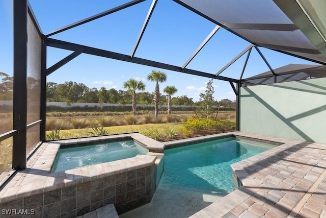 view of pool with an in ground hot tub and a lanai