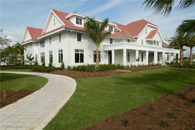 rear view of property featuring a lawn