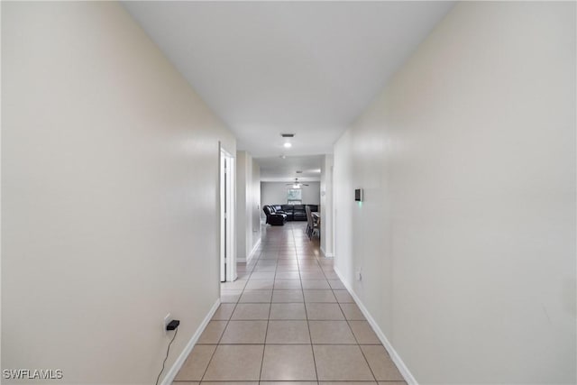 corridor featuring light tile patterned flooring