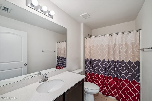 bathroom featuring tile patterned floors, vanity, and toilet