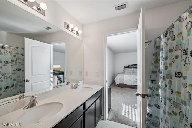 bathroom featuring vanity, tile patterned floors, and walk in shower