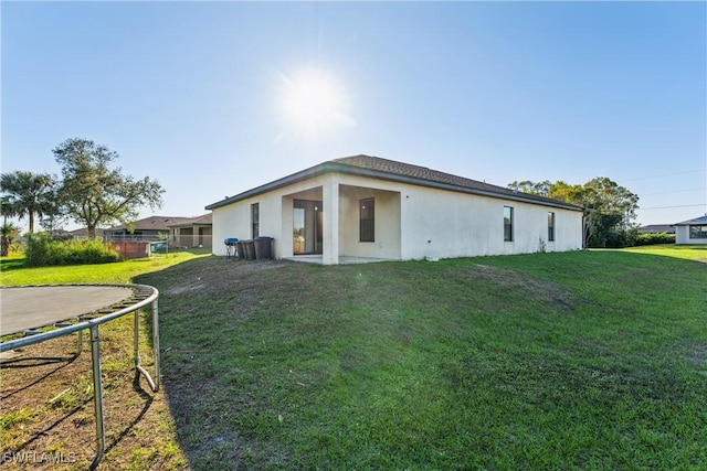 back of property featuring a lawn