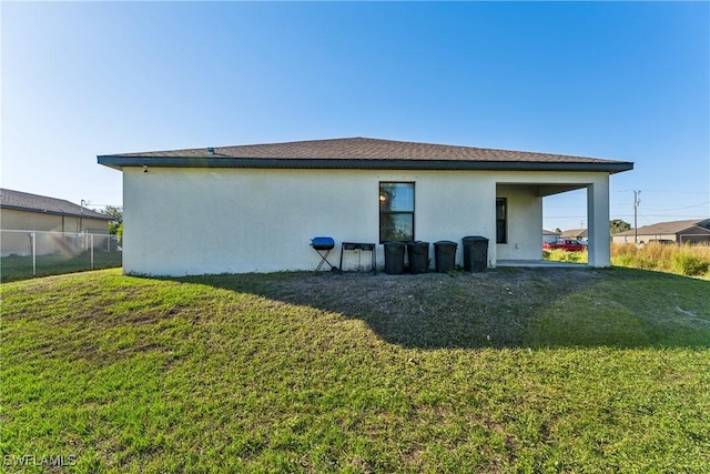 back of house with a yard