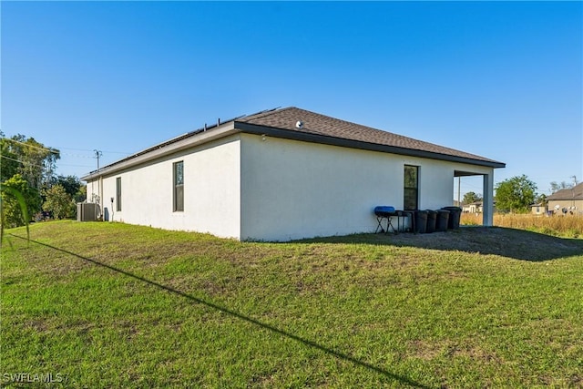 view of side of property featuring cooling unit and a lawn