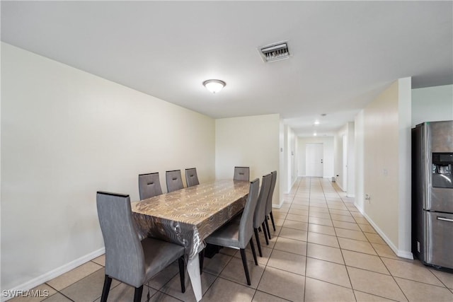 dining space with light tile patterned floors