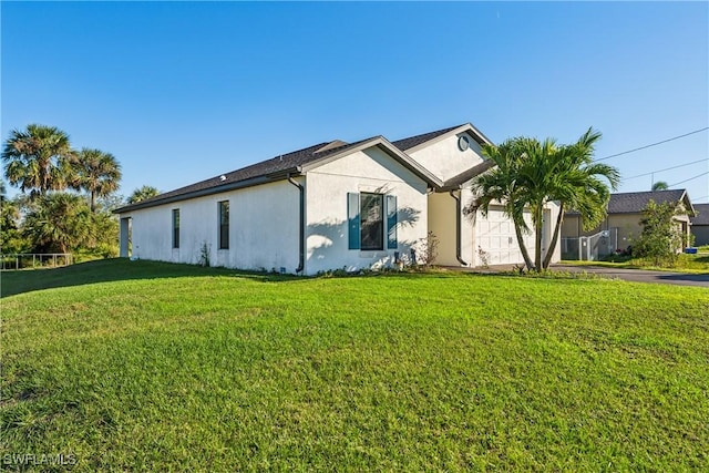 view of home's exterior featuring a lawn and a garage