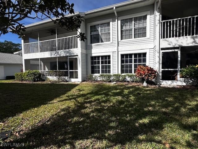 rear view of property featuring a yard