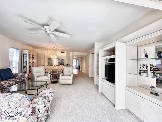 living room featuring light colored carpet and ceiling fan