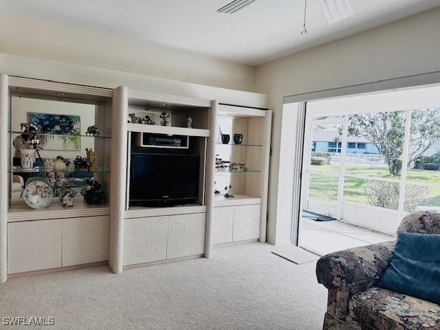 carpeted living room featuring a healthy amount of sunlight