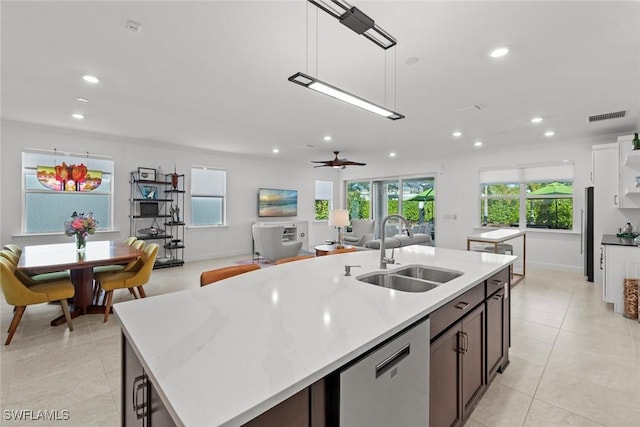 kitchen with pendant lighting, a center island with sink, sink, ceiling fan, and stainless steel appliances