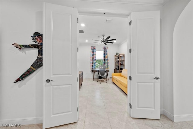 corridor with light tile patterned floors and ornamental molding