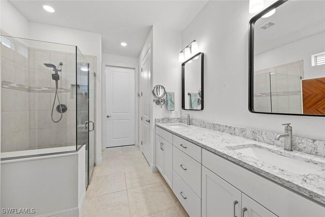 bathroom with tile patterned floors, vanity, and walk in shower