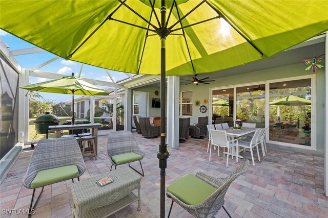 view of patio / terrace featuring a lanai, a grill, and an outdoor living space