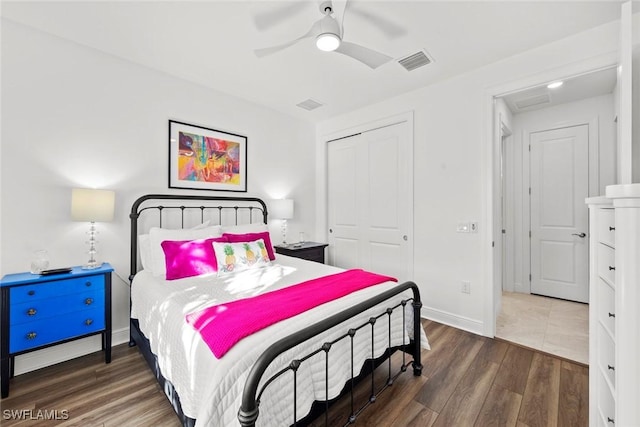 bedroom with ceiling fan, dark hardwood / wood-style flooring, and a closet