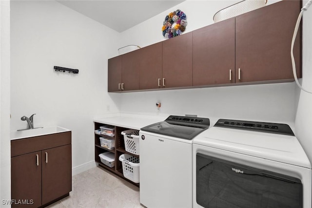 clothes washing area with cabinets, light tile patterned floors, separate washer and dryer, and sink