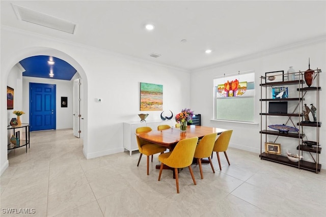 dining space featuring light tile patterned floors and crown molding