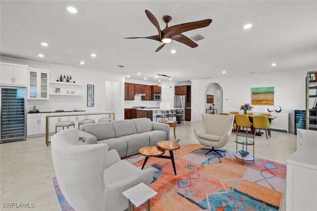 living room featuring ceiling fan and light tile patterned floors