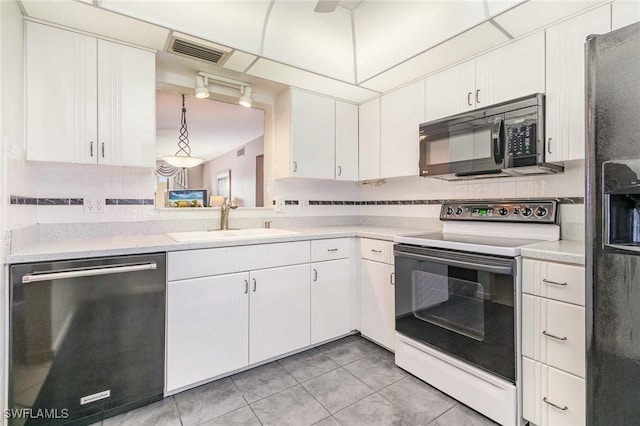 kitchen featuring white cabinets, electric stove, sink, hanging light fixtures, and stainless steel dishwasher