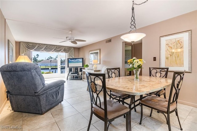 dining room with ceiling fan and light tile patterned flooring