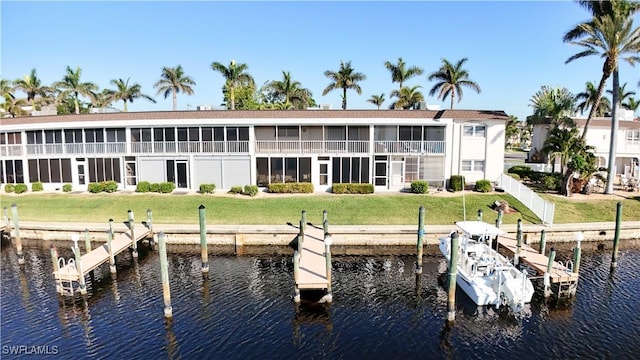 view of dock featuring a water view and a lawn