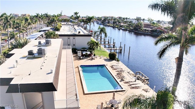 view of pool featuring a patio area and a water view