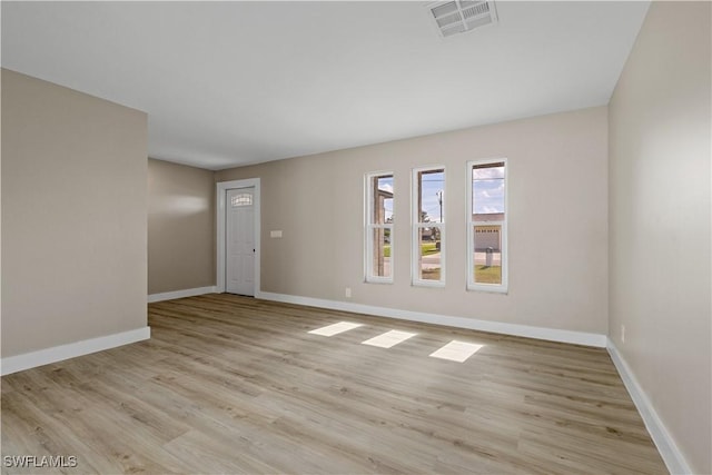 spare room with light hardwood / wood-style floors