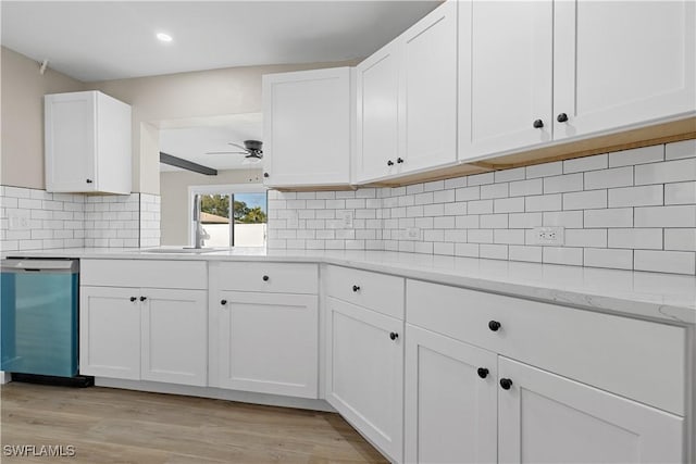 kitchen with white cabinetry, dishwasher, ceiling fan, light stone counters, and backsplash