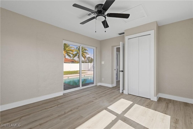 unfurnished bedroom with ceiling fan, a closet, and light hardwood / wood-style flooring