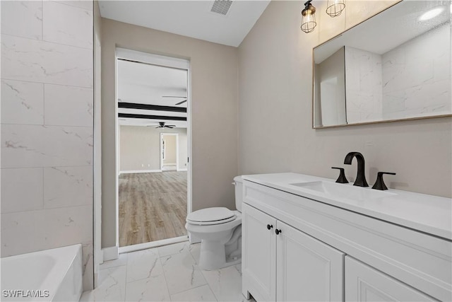 bathroom with ceiling fan, toilet, and vanity