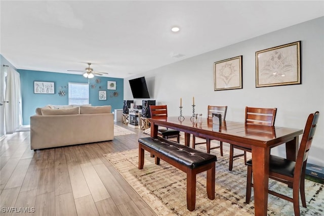 dining room with ceiling fan and light wood-type flooring