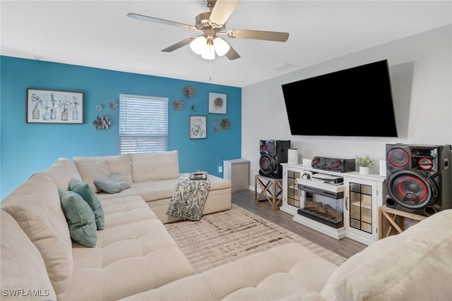 living room featuring ceiling fan and light hardwood / wood-style floors