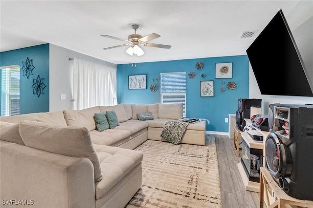 living room featuring light hardwood / wood-style flooring and ceiling fan