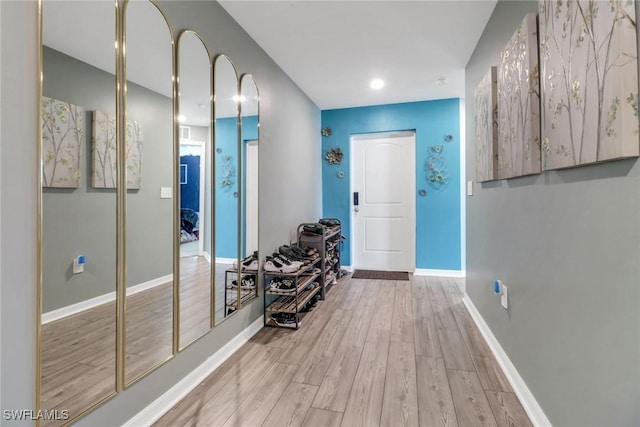 corridor with light hardwood / wood-style flooring