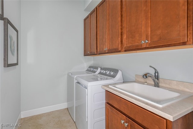 laundry room featuring cabinets, sink, light tile patterned floors, and washer and dryer