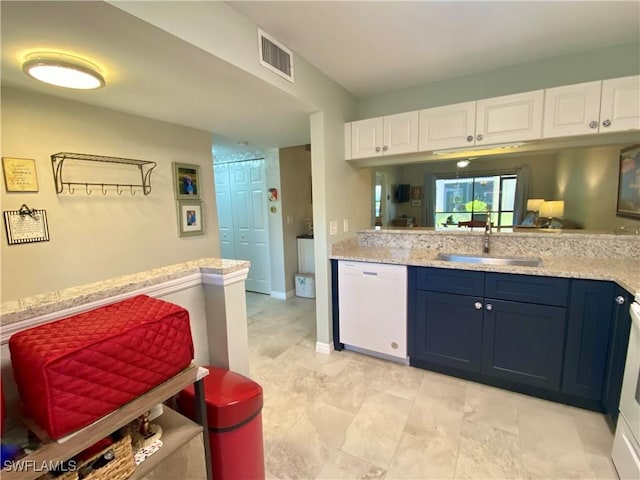 kitchen featuring blue cabinets, dishwasher, sink, and white cabinets