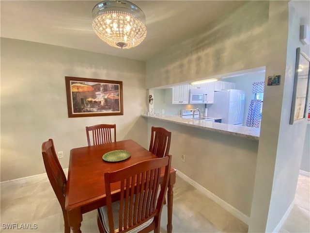 dining space featuring a notable chandelier