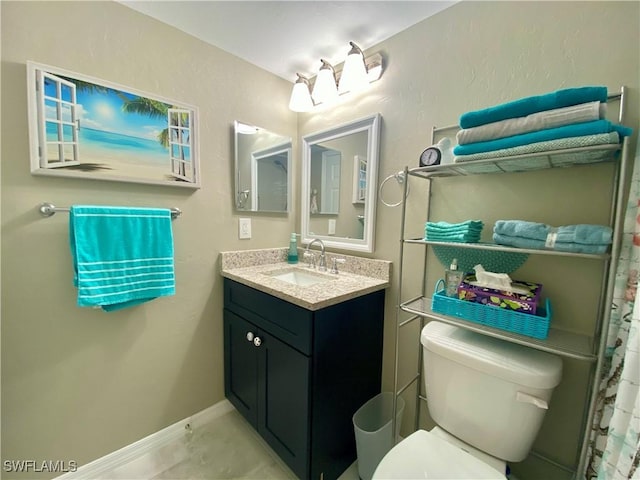 bathroom with vanity, tile patterned floors, and toilet