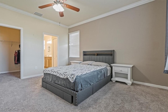 bedroom featuring a walk in closet, crown molding, carpet flooring, ceiling fan, and a closet