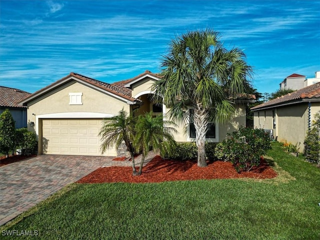 view of front of house with a front yard and a garage