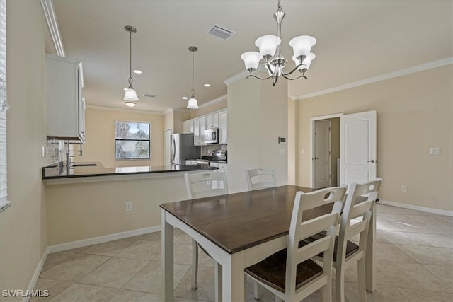 dining area featuring light tile patterned floors, an inviting chandelier, crown molding, and sink