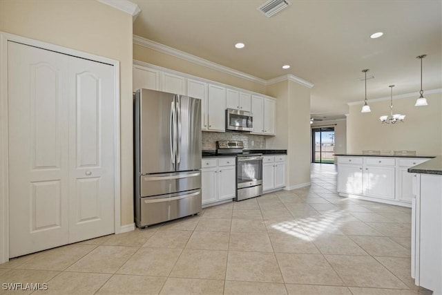 kitchen featuring white cabinets, light tile patterned floors, stainless steel appliances, and hanging light fixtures