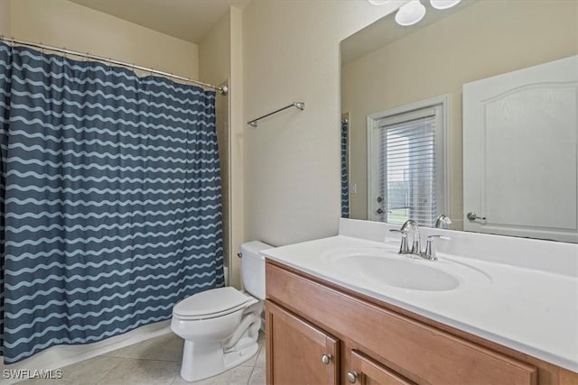 bathroom with tile patterned flooring, vanity, and toilet