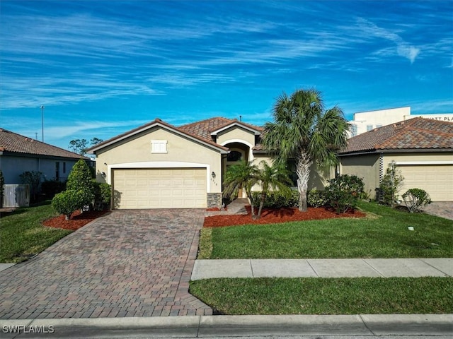 view of front of home featuring a garage and a front lawn