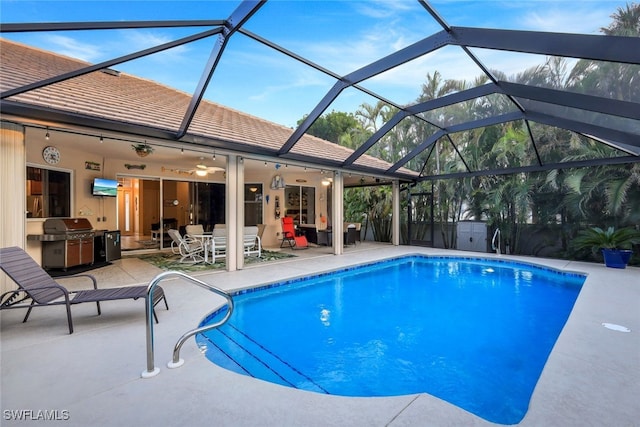 view of pool featuring ceiling fan, area for grilling, a lanai, and a patio