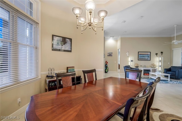 dining room featuring ceiling fan with notable chandelier, ornamental molding, and light tile patterned floors