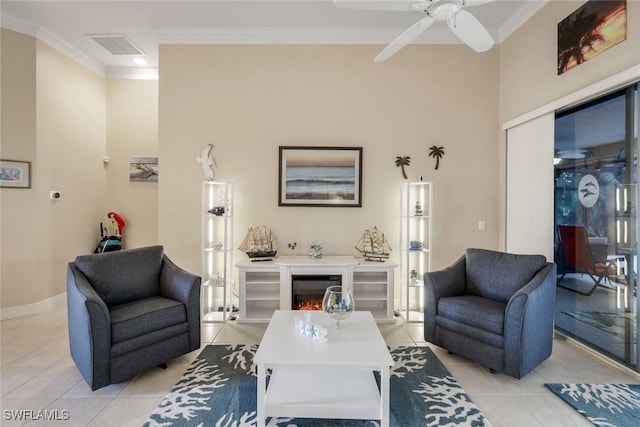 living room with crown molding, light tile patterned floors, and ceiling fan