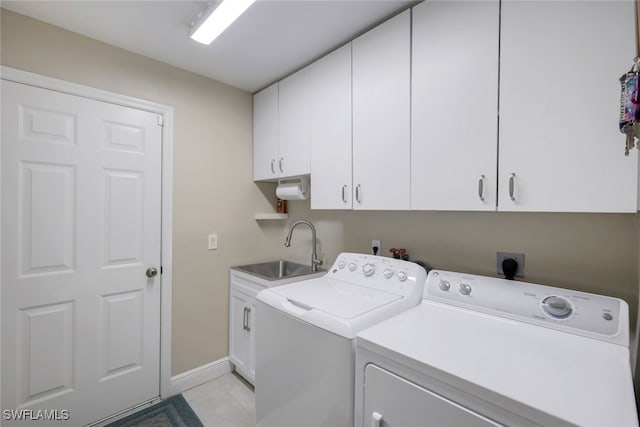 laundry room with independent washer and dryer, a sink, cabinet space, and baseboards