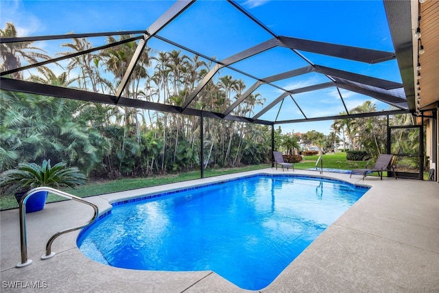 outdoor pool featuring a lanai and a patio area